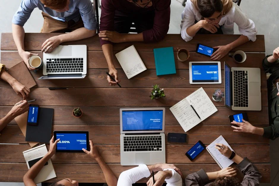 Focused business analysis with charts and graphs on a laptop in a modern office setting.